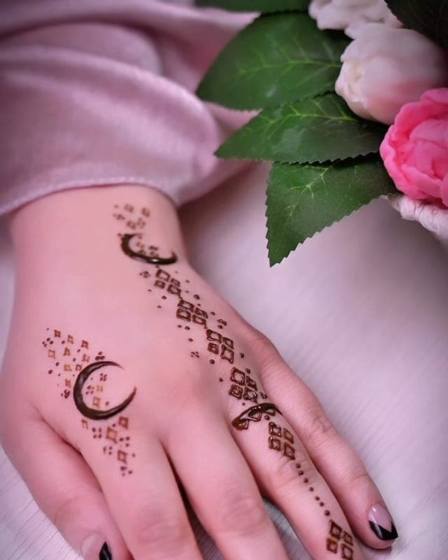 Qoʻlda oy shaklidagi xina naqshi va qora tirnoq dekori
